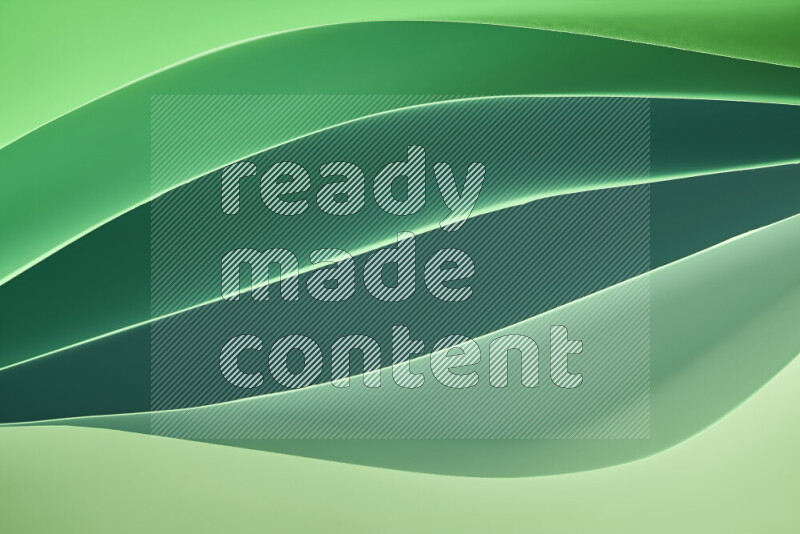 This image showcases an abstract paper art composition with paper curves in green gradients created by colored light