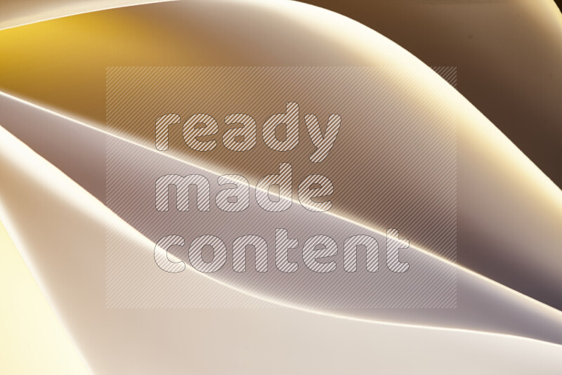 This image showcases an abstract paper art composition with paper curves in gold gradients created by colored light