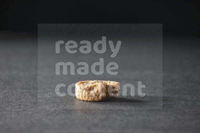A dried fig on a black background in different angles