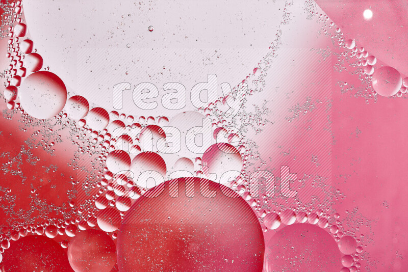 Close-ups of abstract oil bubbles on water surface in shades of white, red and pink