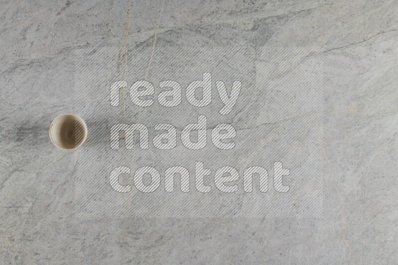 A multicolored pottery Cup on grey marble background