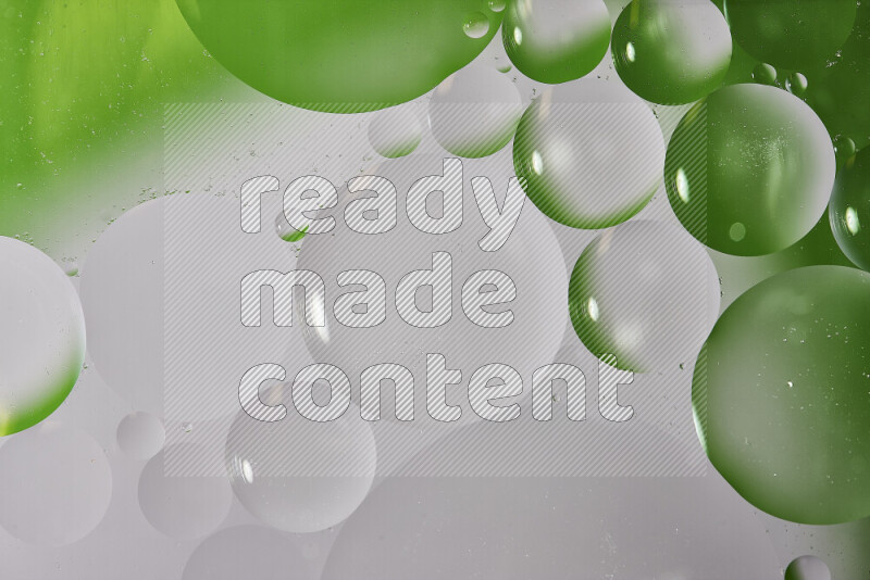 Close-ups of abstract oil bubbles on water surface in shades of white and green