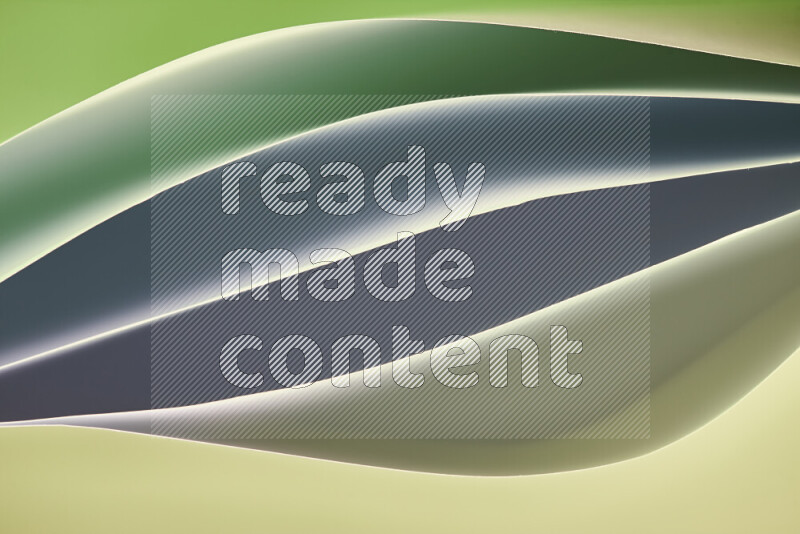 This image showcases an abstract paper art composition with paper curves in green gradients created by colored light