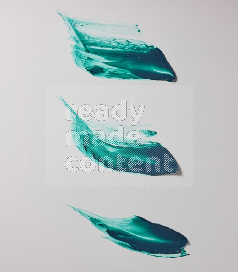 Turquoise painting knife strokes on white background