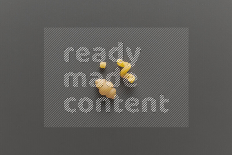 Different pasta types on grey background