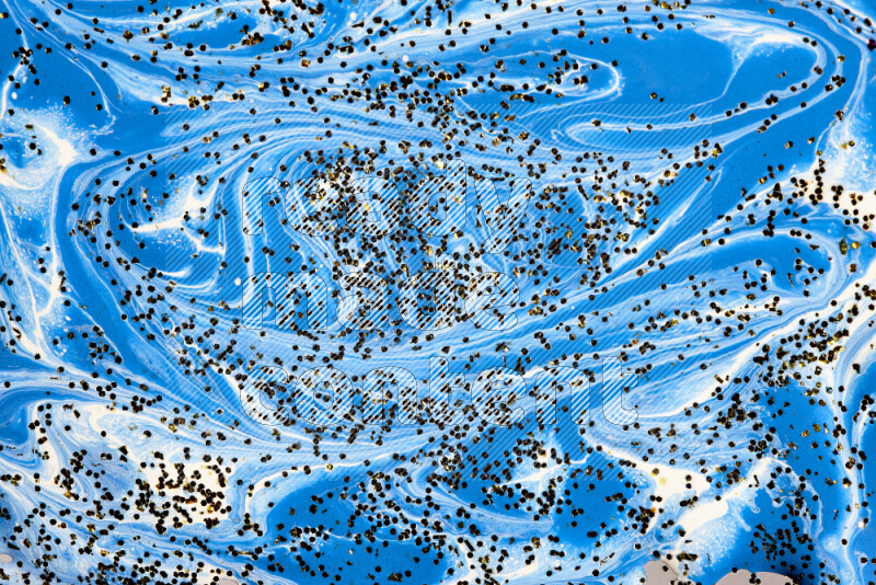 Abstract colorful background with mixed of blue and white paint colors with scattered gold glitter