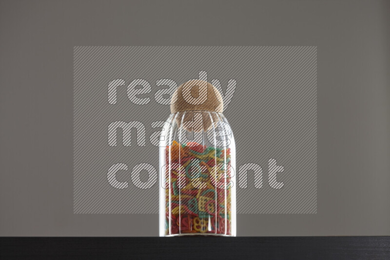 Snacks in a glass jar on black background