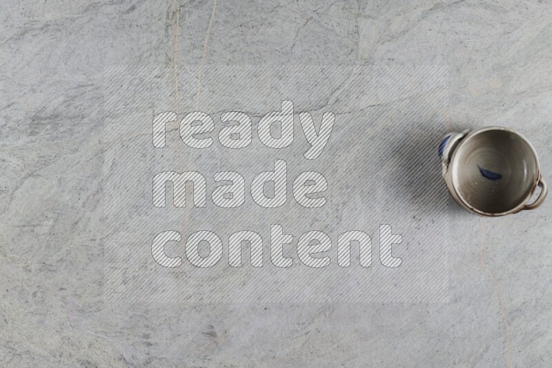 A multicolored pottery Bowl on grey marble background
