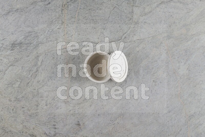 A multicolored pottery Cup on grey marble background
