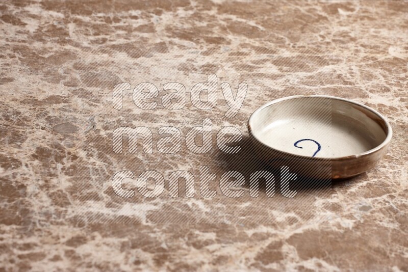 Multicolored Pottery Bowl on Beige Marble Flooring