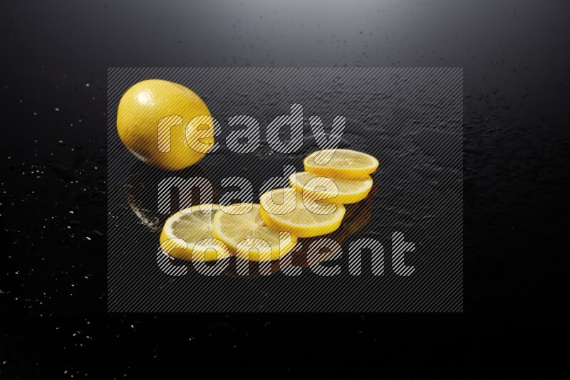Lemon slices with water drops, and droplets on black background