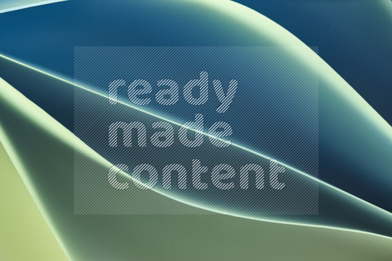 This image showcases an abstract paper art composition with paper curves in green and blue gradients created by colored light