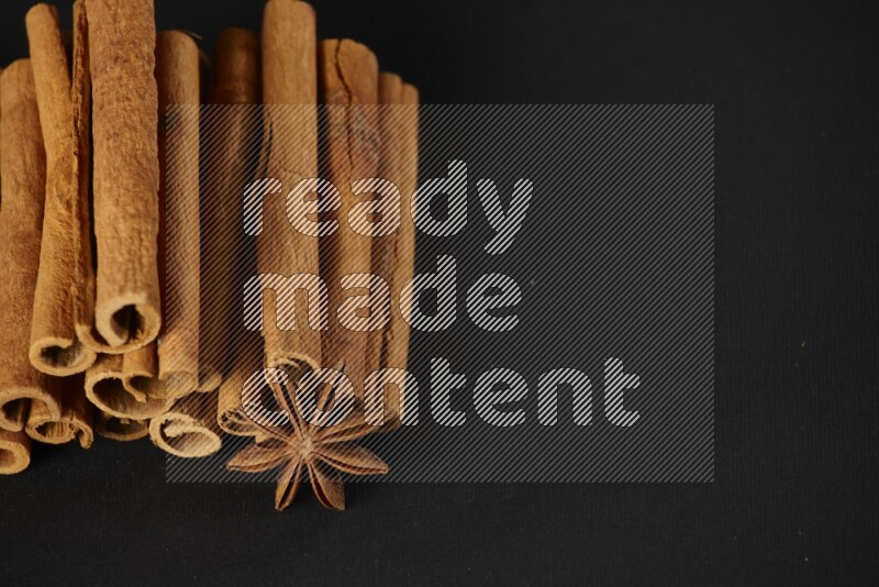 Cinnamon sticks and star anise on a black background