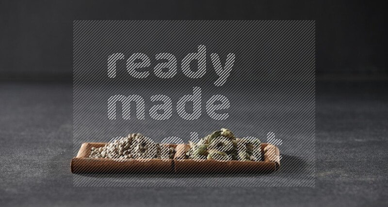 2 squares of cinnamon sticks full of white peppers and cardamom on black flooring