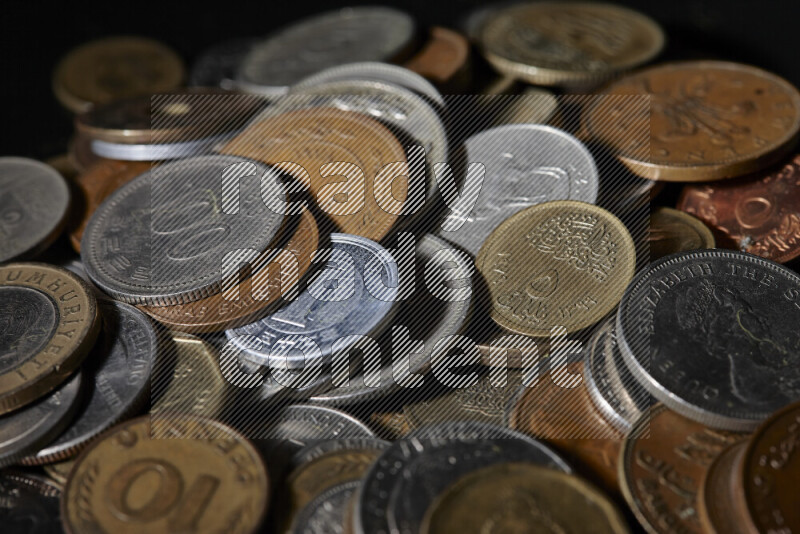 A close-ups of random old coins on black background
