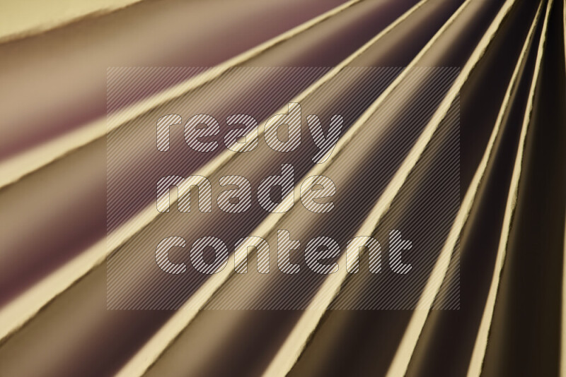 An image presenting an abstract paper pattern of lines in red and gold tones