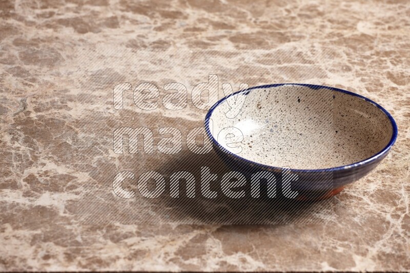 Multicolored Pottery Bowl on Beige Marble Flooring
