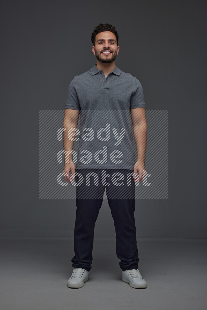 A man wearing casual making multi stand poses  eye level on a gray background