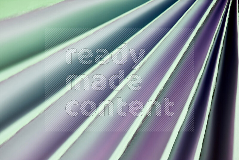 An image presenting an abstract paper pattern of lines in green and pink tones