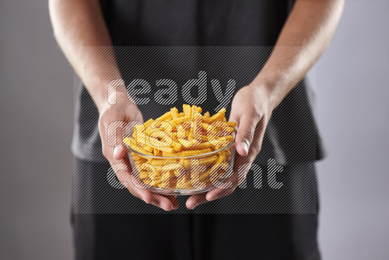 Woman in abaya holding different kinds of snacks in different positions