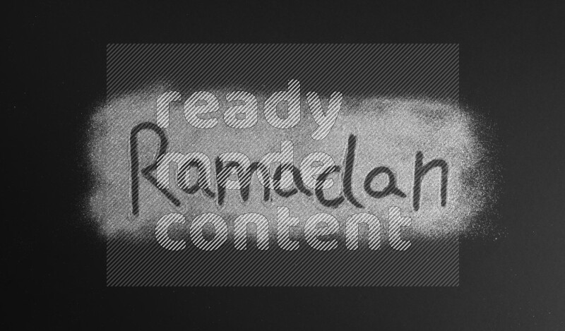 A word written with silver glitter on black background