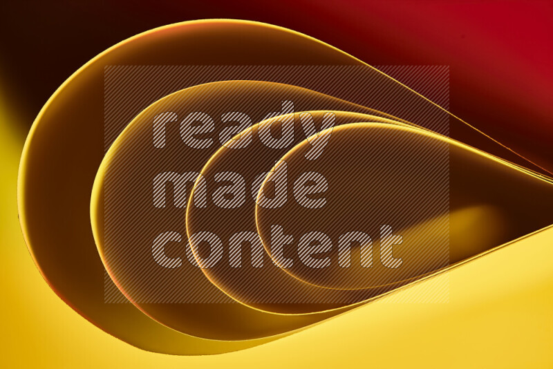 An abstract art of paper folded into smooth curves in yellow, brown and red gradients
