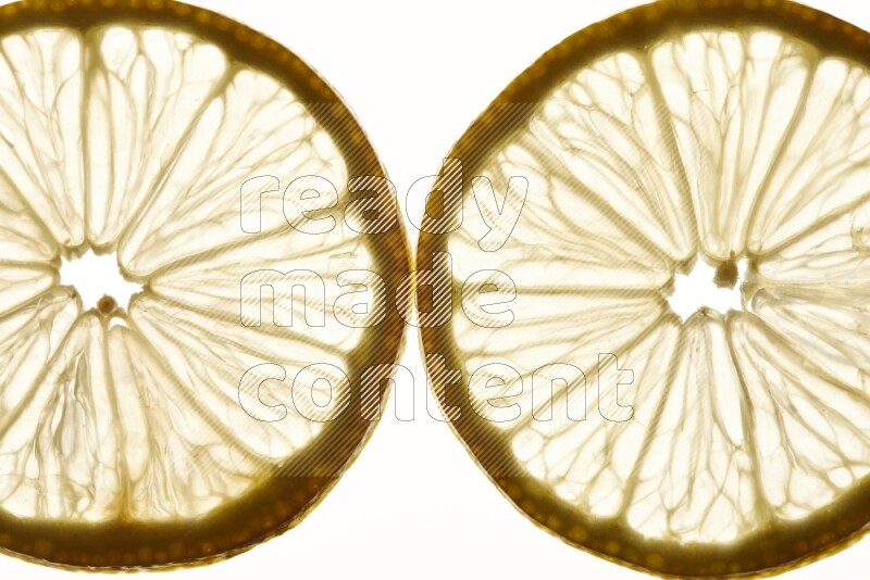 Lemon slices on illuminated white background