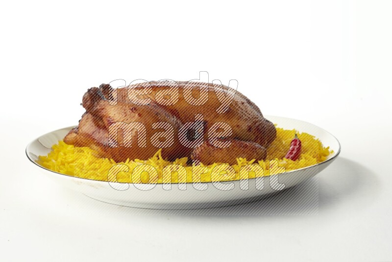 yellow  basmati Rice with kabsa chicken pieces on a white plate with a silver rim direct on white background