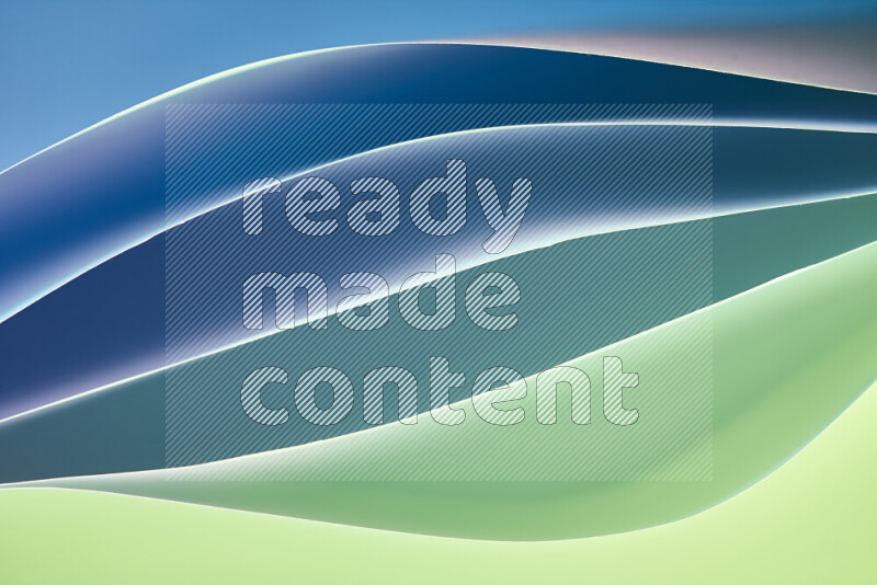 This image showcases an abstract paper art composition with paper curves in green and blue gradients created by colored light