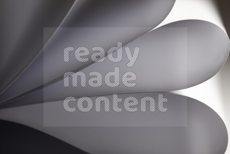 An abstract art showing grey paper sheets arranged in an overlapping curves