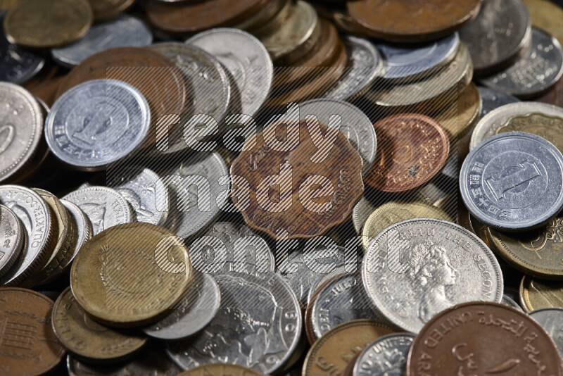 A close-ups of random old coins on black background