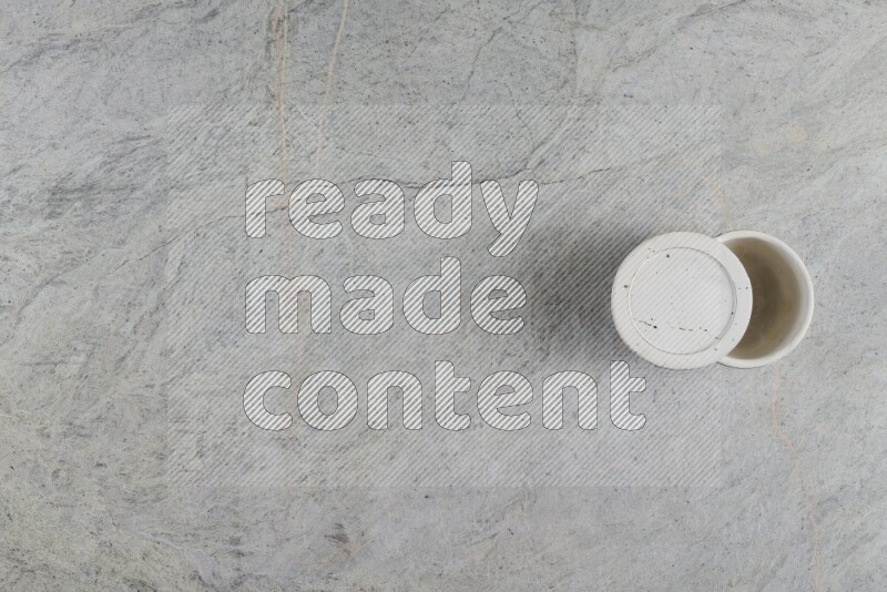 A multicolored pottery Cup on grey marble background