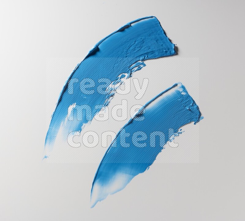 Blue curved painting knife strokes on white background