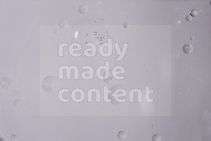 Abstract oil droplets in a water surface on white background