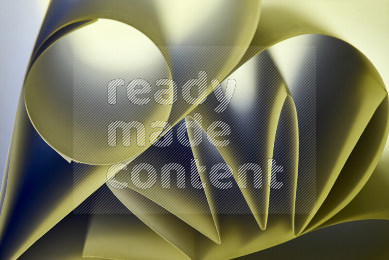 An artistic display of paper folds creating a harmonious blend of geometric shapes, highlighted by soft lighting in green tones