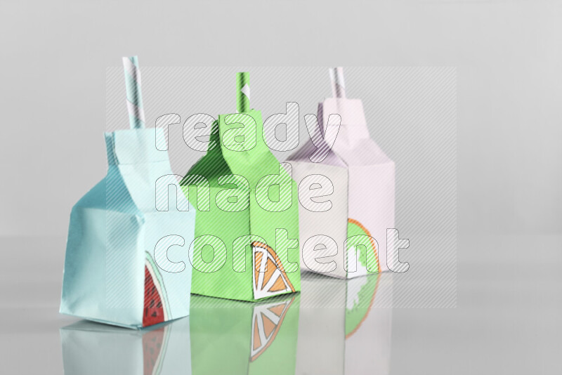 Origami juice box on grey background