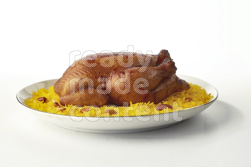 yellow  basmati Rice with kabsa chicken pieces on a white plate with a silver rim direct on white background