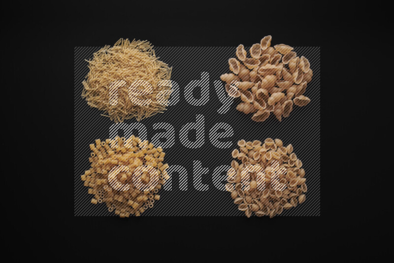 Different pasta types in bunches on black background