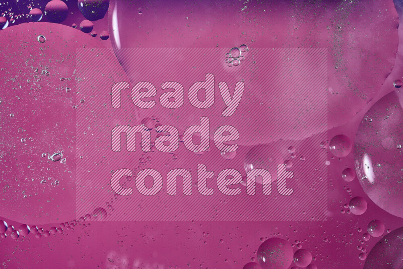 Close-ups of abstract oil bubbles on water surface in shades of purple and pink