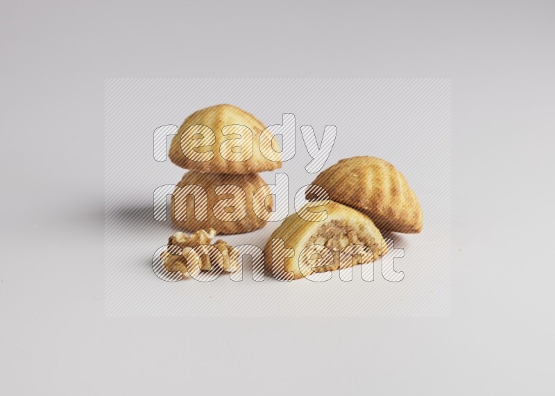 Four Pieces of Maamoul filled with walnut paste  one of them is cut direct on white background