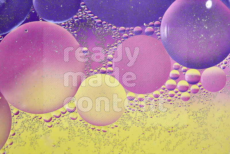 Close-ups of abstract oil bubbles on water surface in shades of yellow, purple and pink