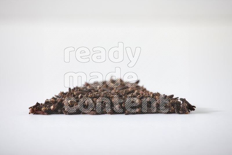 cloves in a triangle shape on a white flooring